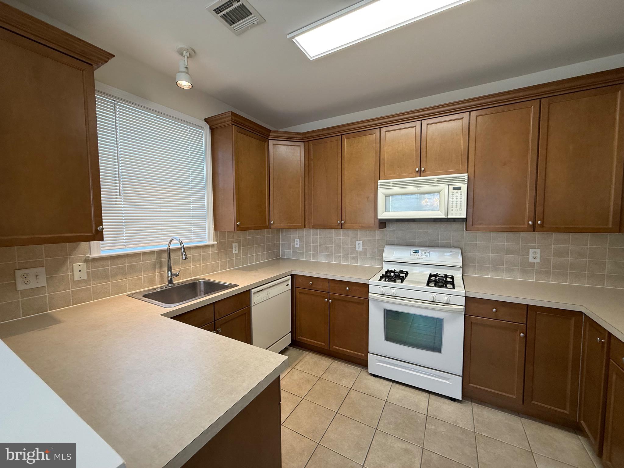 231 Masterson Court Ewing, NJ 08618 - Photo 13 of 43 a kitchen with stainless steel appliances granite countertop a sink stove and microwave