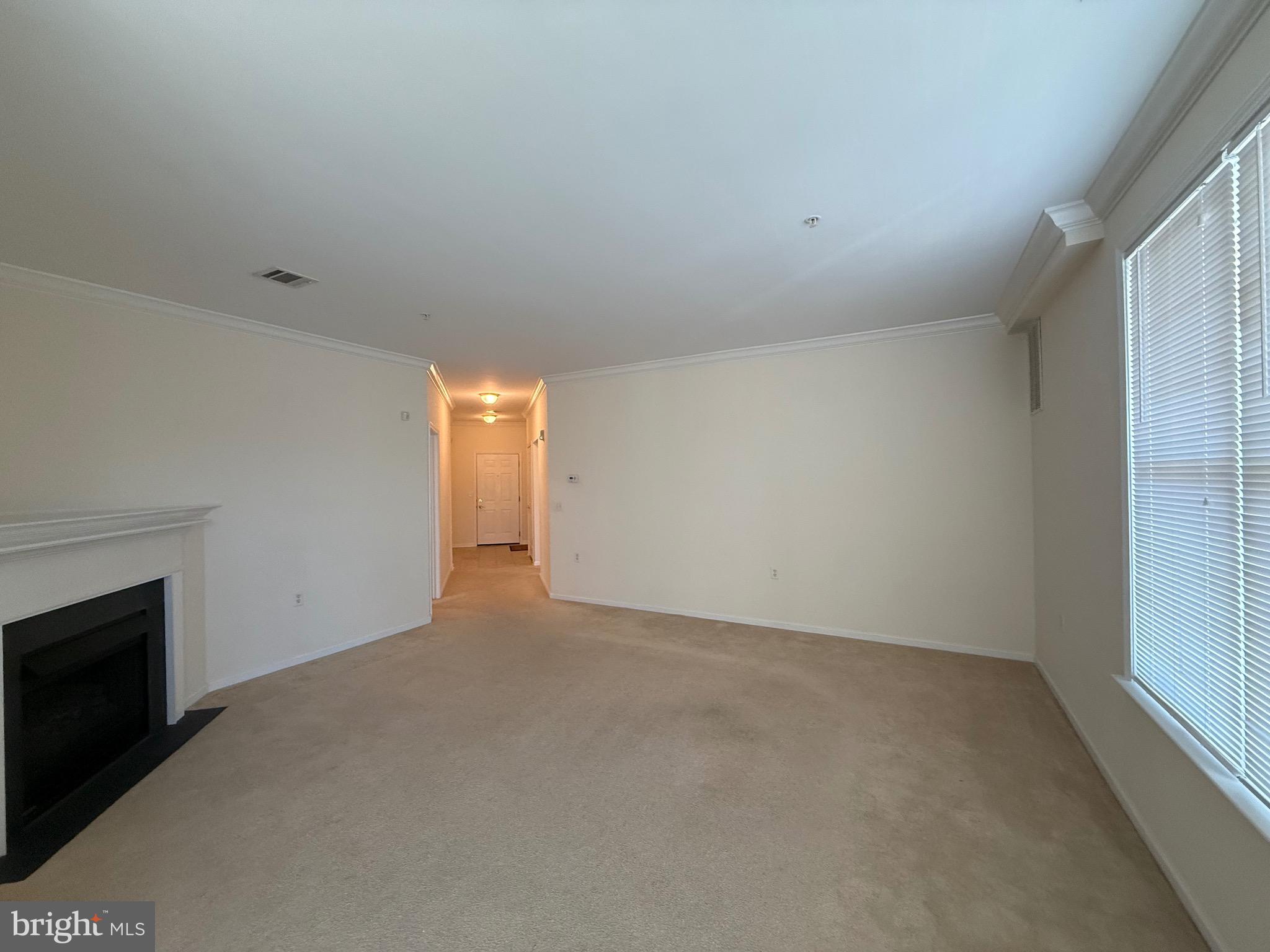 231 Masterson Court Ewing, NJ 08618 - Photo 8 of 43 a view of an empty room with a fireplace and a window