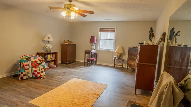 a view of a livingroom with furniture and a window