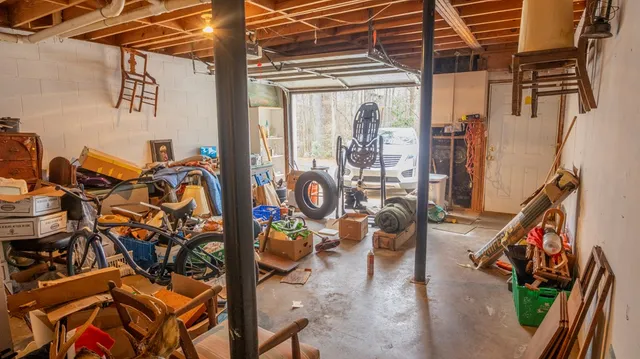 an aerial view of a house with a yard and large tree