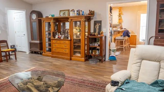 a view of a workspace with furniture and a window