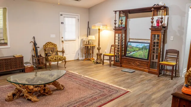 a very nice looking dining room with a large window and kitchen view