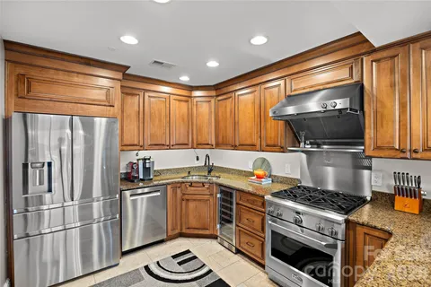 a kitchen with a sink appliances and cabinets