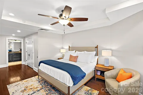 a bedroom with bed and wooden floor