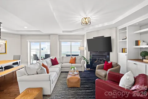 a living room with furniture or kitchen view and a flat screen tv