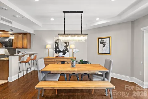 a dining room with a table chairs and kitchen view