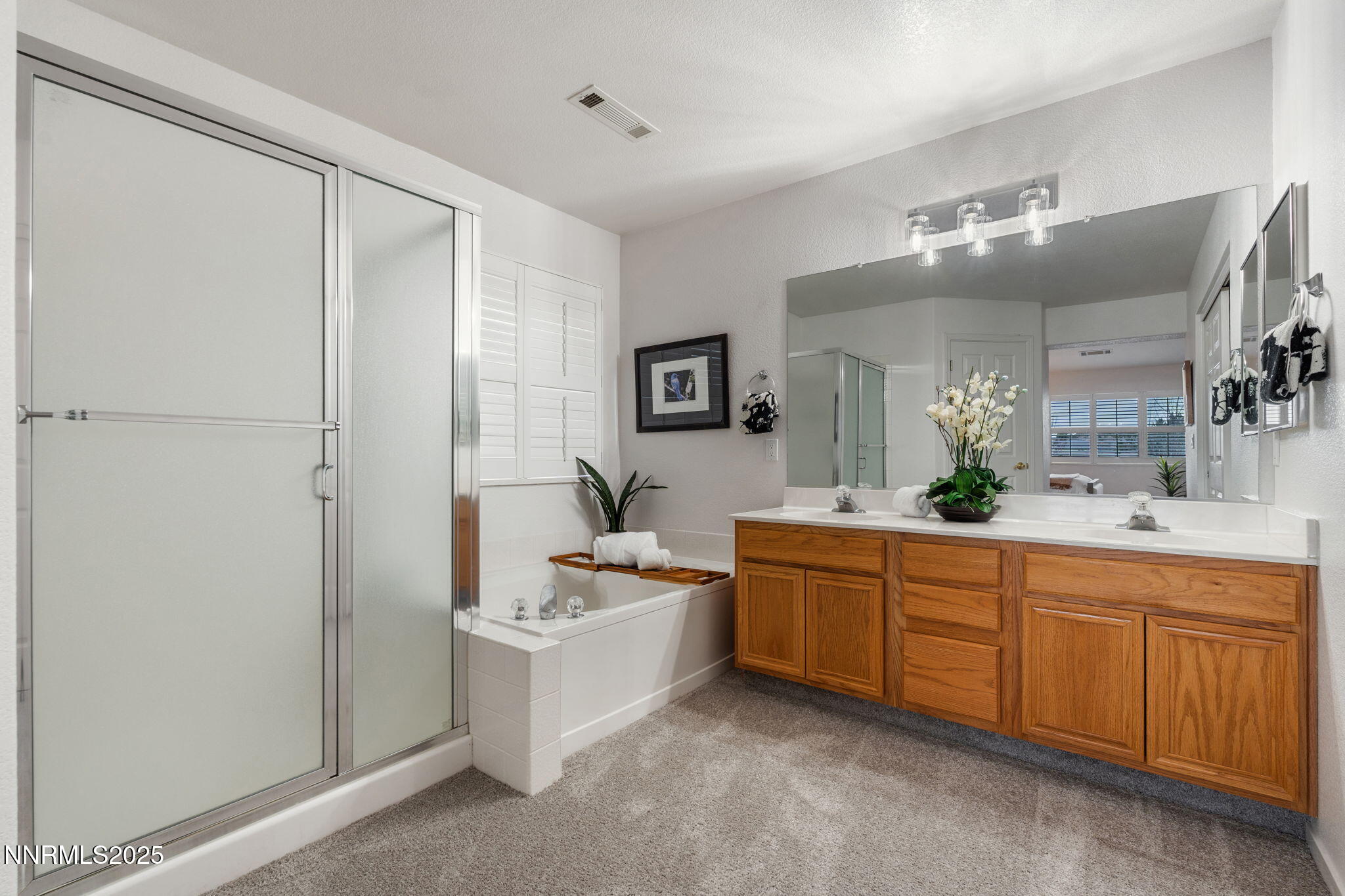 485 Corvallis Court Reno, NV 89511 - Photo 26 of 34 a large bathroom with a double vanity sink a mirror and a bathtub