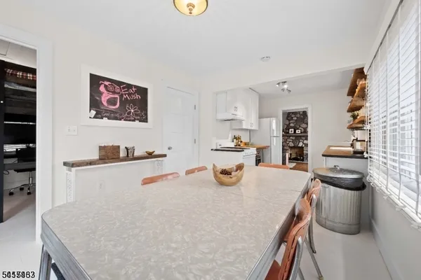 a kitchen with a table chairs and a refrigerator