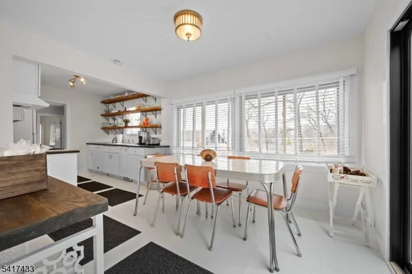 a view of a dining room with furniture and a window