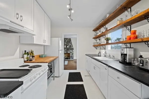 a kitchen with stainless steel appliances a stove a sink and cabinets