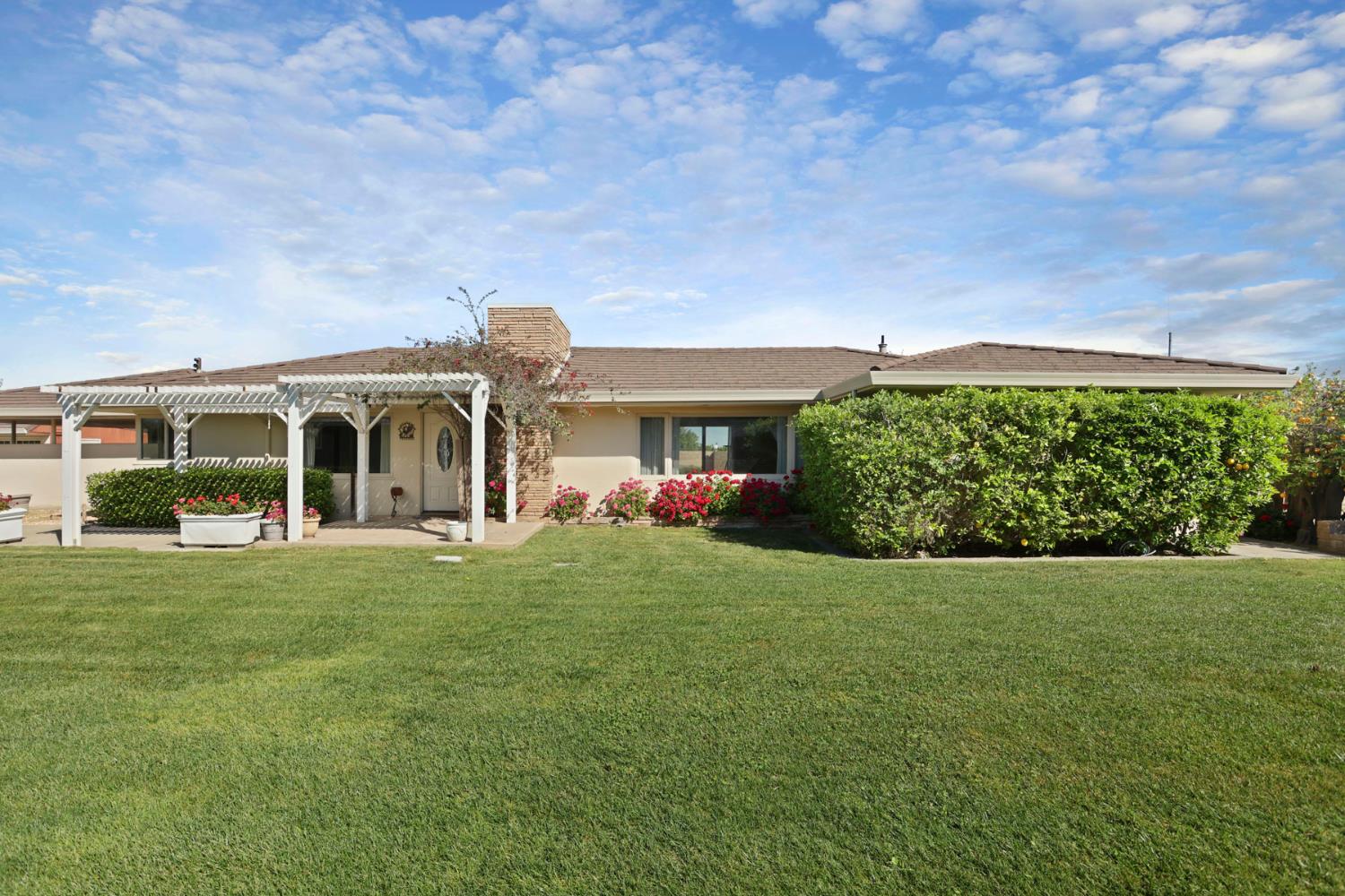 2465 Vernalis Road Tracy, CA 95304 - Photo 2 of 55 a front view of a house with a garden