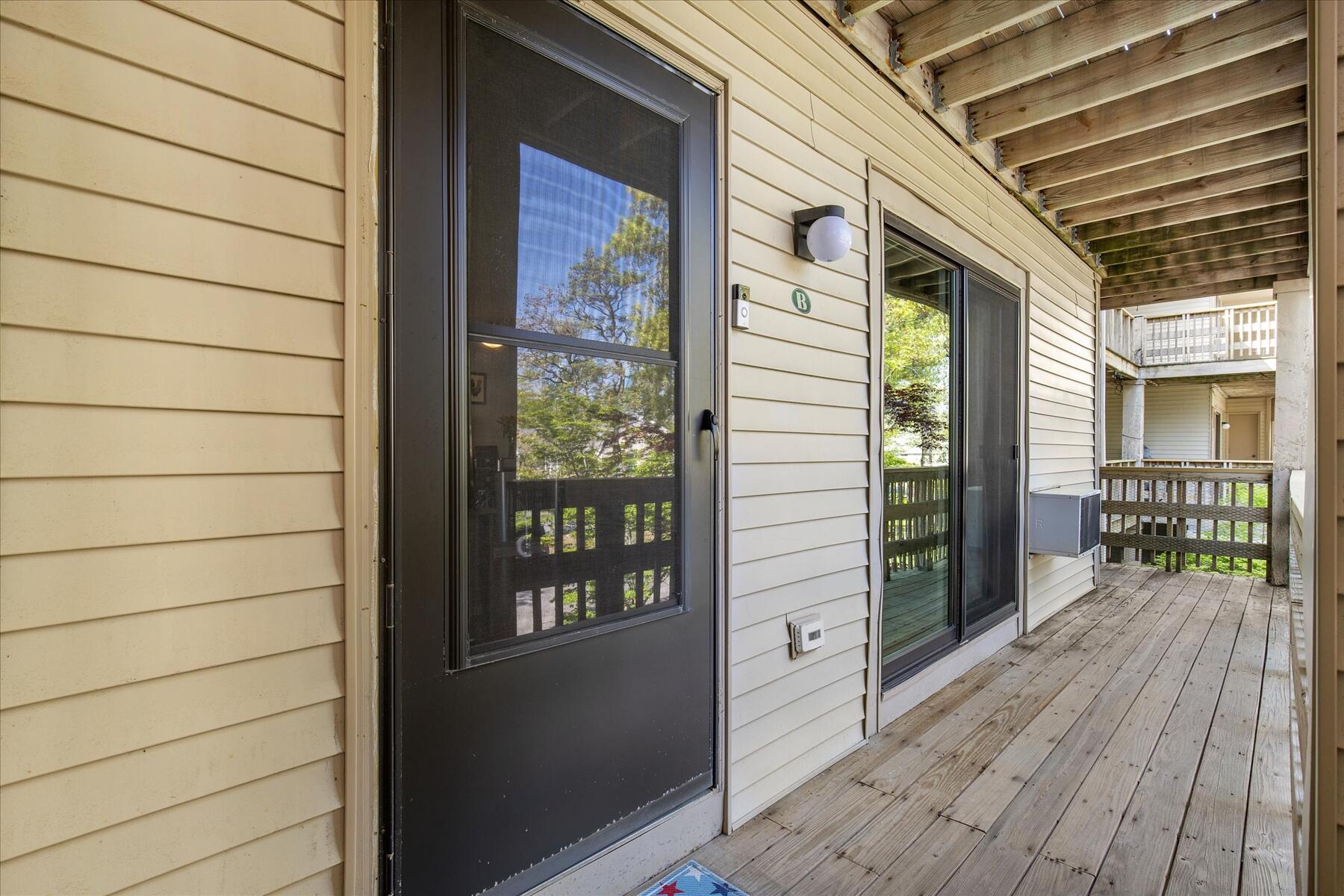 800 Bearses Way, Unit 1EB Hyannis, MA 02601 - Photo 5 of 37 a view of a porch with wooden floor and floor to ceiling window