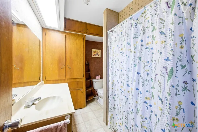 a bedroom with furniture and a flat screen tv