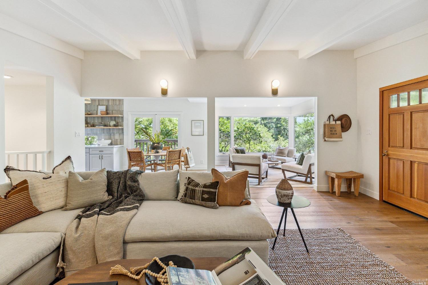 a living room with furniture and large windows