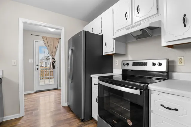 a kitchen with stainless steel appliances granite countertop a stove a refrigerator and a microwave