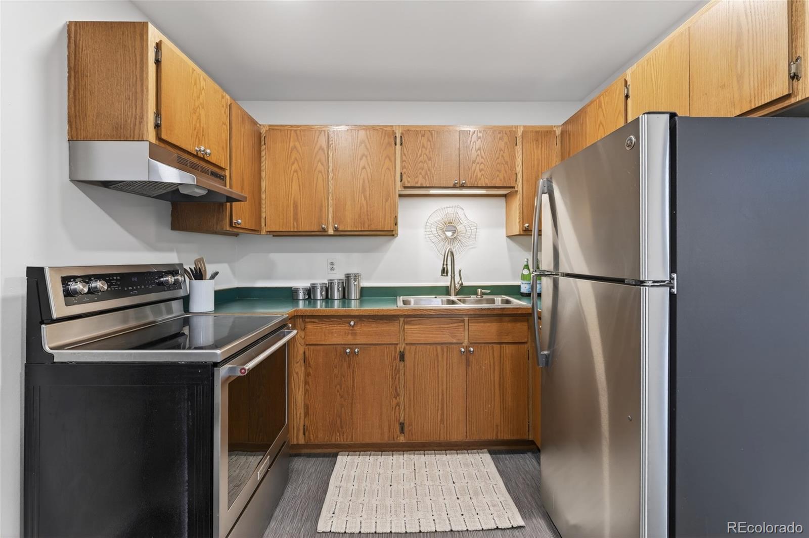 551 Cherokee Street Denver, CO 80204 - Photo 12 of 25 a kitchen with stainless steel appliances granite countertop a refrigerator a stove and a sink