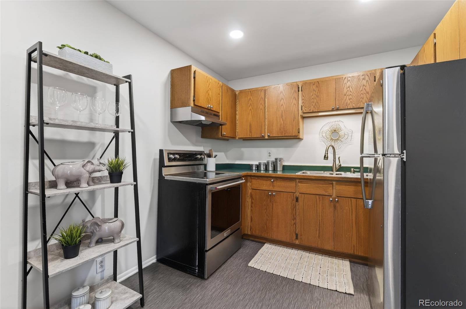 551 Cherokee Street Denver, CO 80204 - Photo 13 of 25 a kitchen with stainless steel appliances granite countertop a refrigerator sink and cabinets