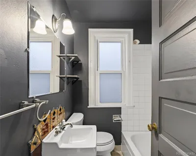 a bathroom with a sink toilet and mirror