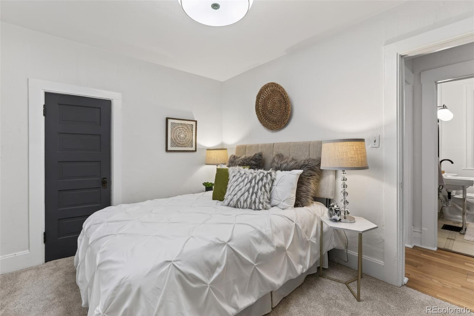 551 Cherokee Street Denver, CO 80204 - Photo 15 of 25 a bedroom with a bed and a lamp