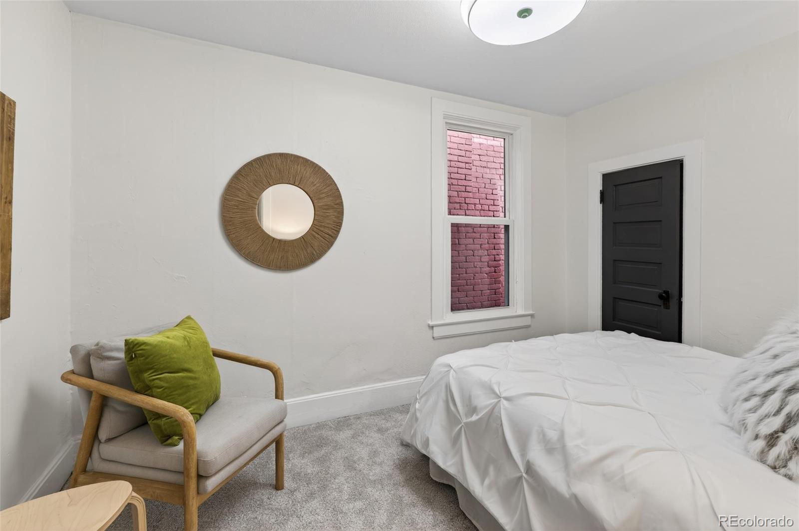 551 Cherokee Street Denver, CO 80204 - Photo 16 of 25 a bedroom with a bed and a chair