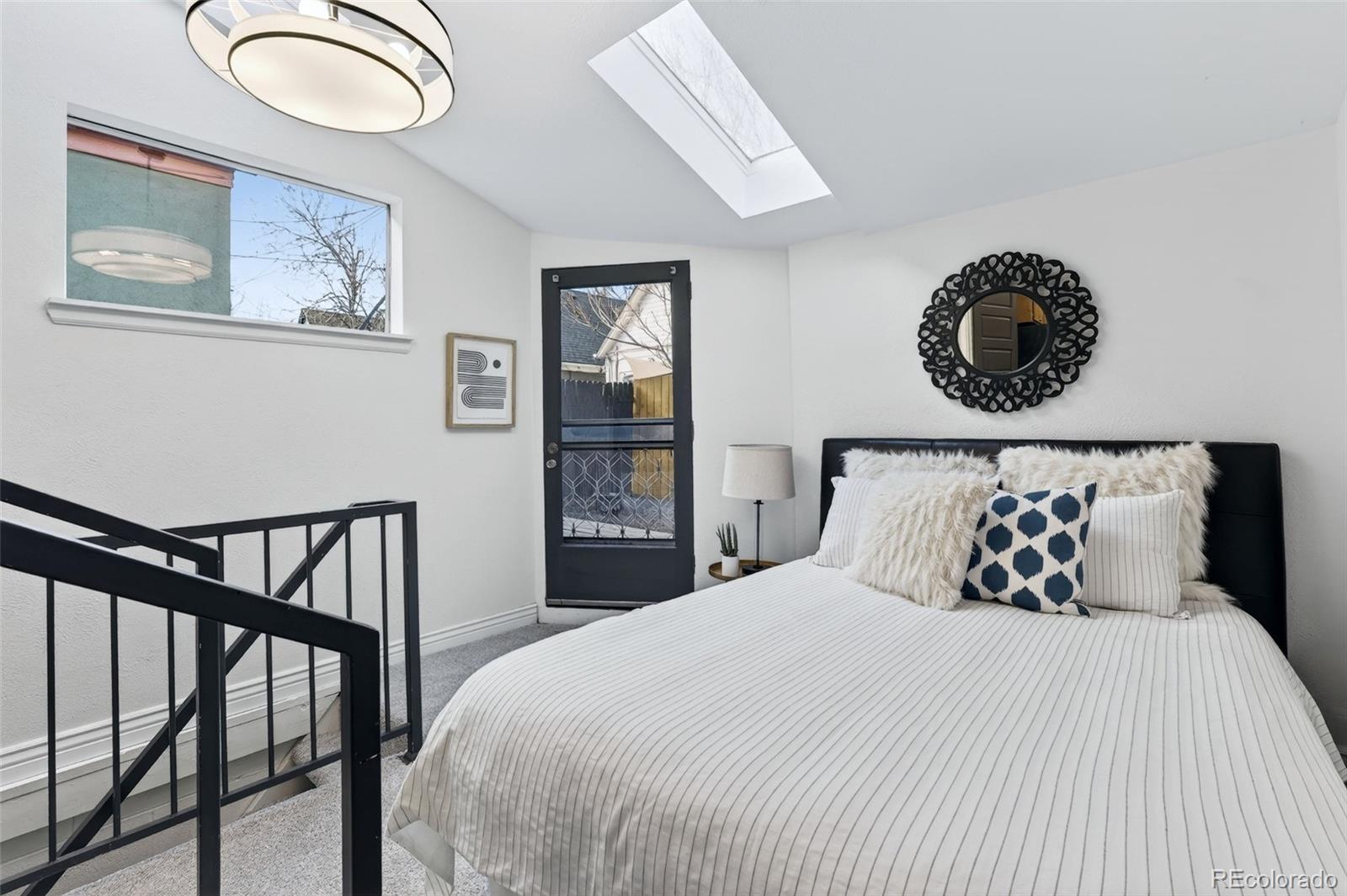 551 Cherokee Street Denver, CO 80204 - Photo 17 of 25 a bedroom with a bed and painting on the wall