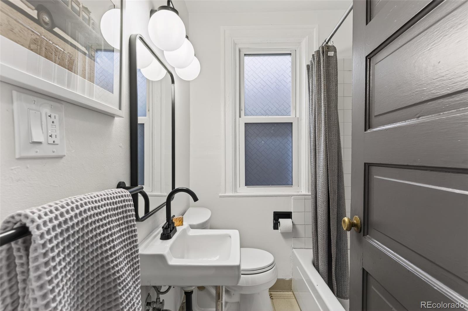 551 Cherokee Street Denver, CO 80204 - Photo 19 of 25 a bathroom with a sink a toilet and shower