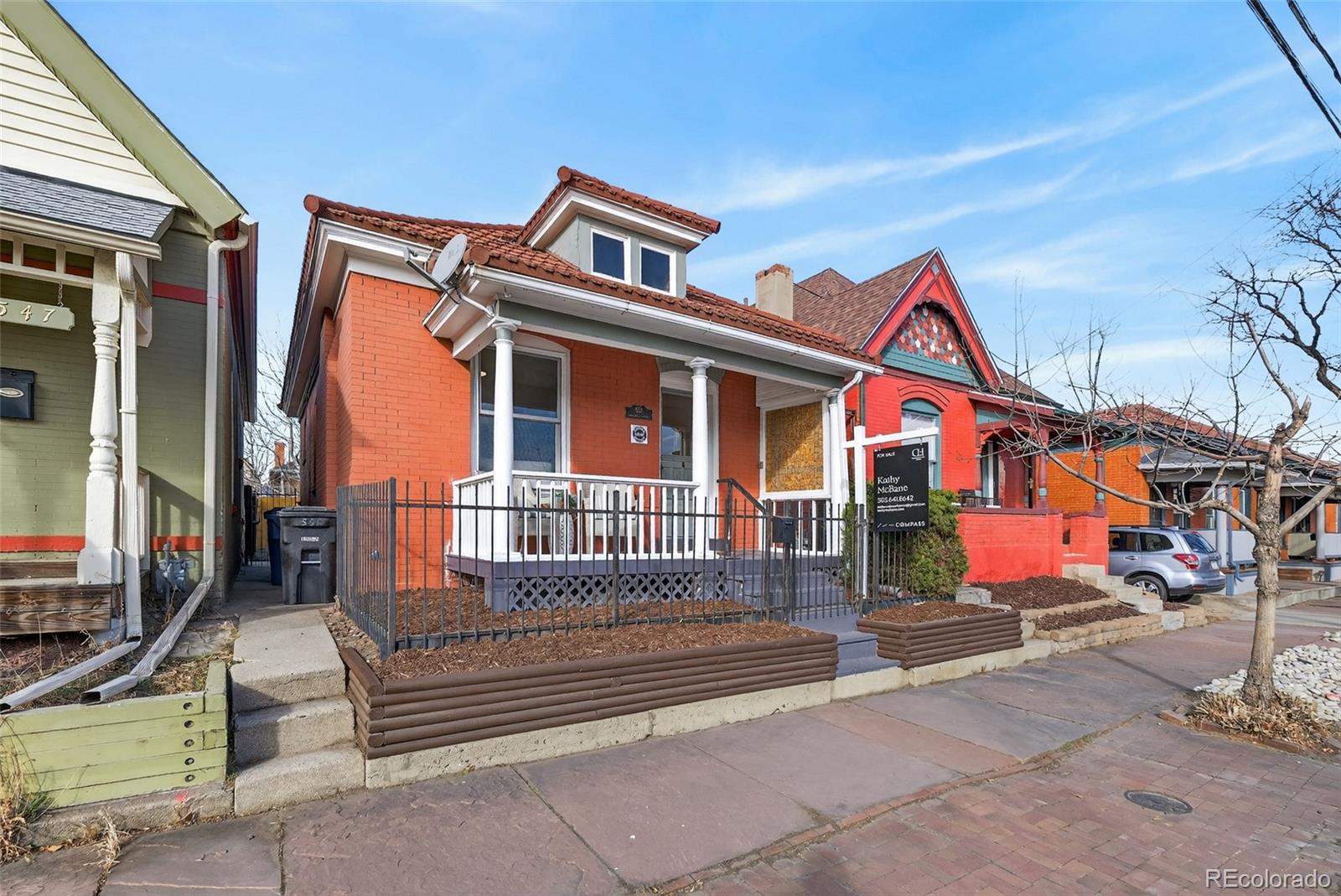 551 Cherokee Street Denver, CO 80204 - Photo 2 of 25 a front view of a house with a yard