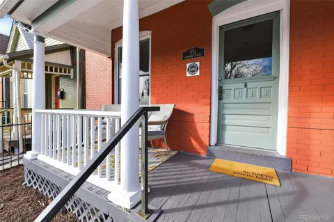 a view of a balcony with furniture and wooden floor