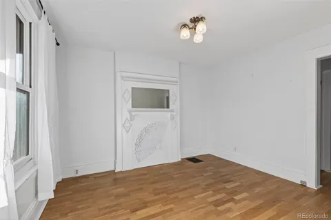 a view of empty room with a fireplace and fan