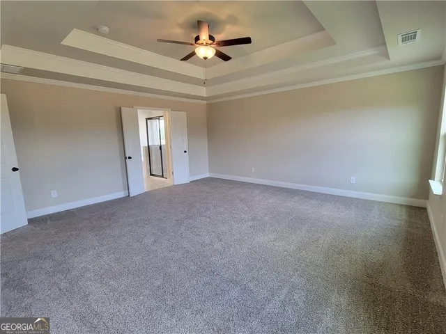 a view of a livingroom with a ceiling fan and window