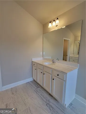 a spacious bathroom with a double vanity sink and a mirror