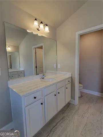 a bathroom with a granite countertop sink a large mirror and a