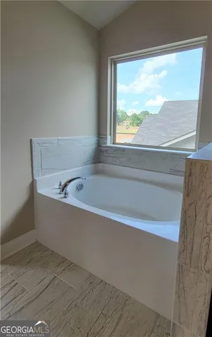 a white bath tub sitting next to a window