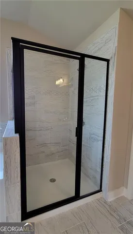 a bathroom with a glass shower door