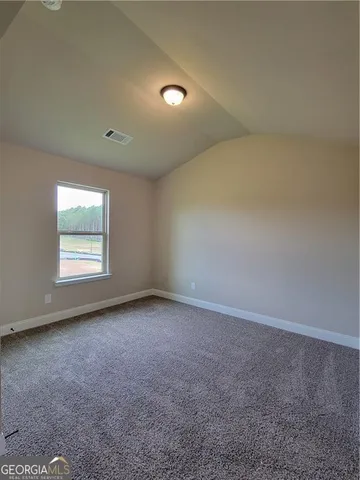 an empty room with a empty space and windows