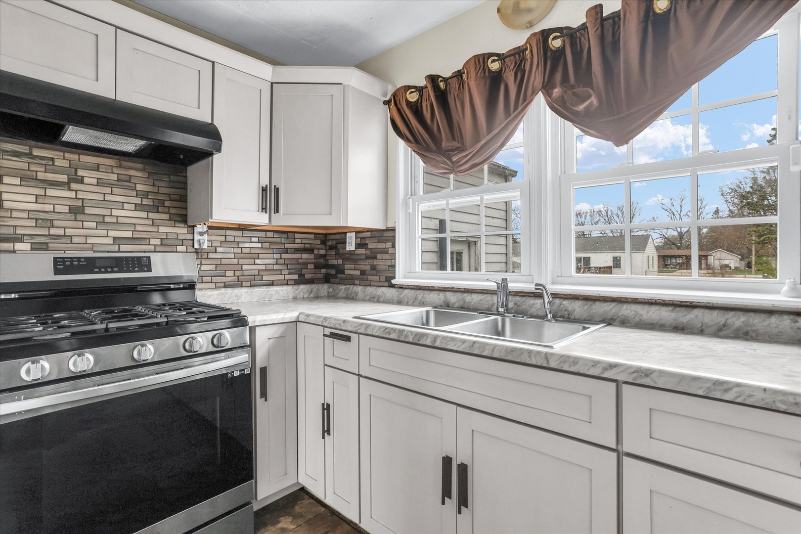 3234 East Fulton Avenue Decatur, IL 62521 - Photo 13 of 34 a kitchen with granite countertop a stove and a sink