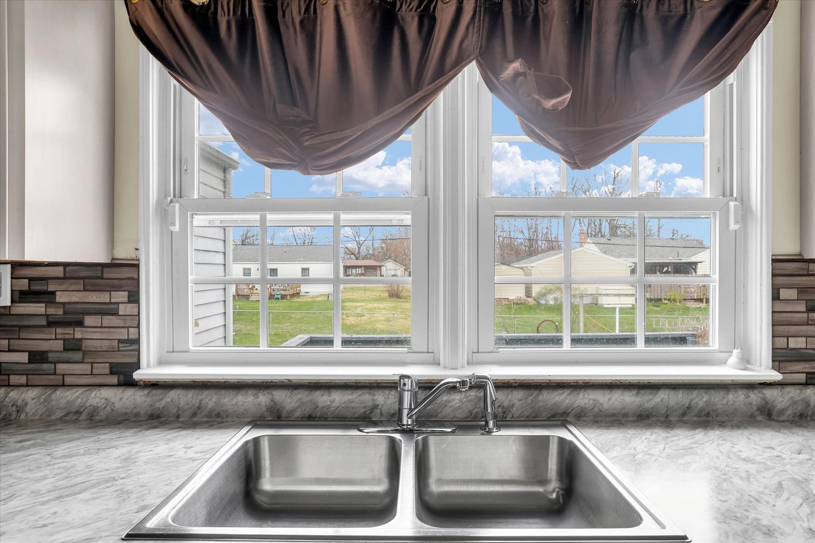 3234 East Fulton Avenue Decatur, IL 62521 - Photo 14 of 34 a kitchen with a sink and a large window