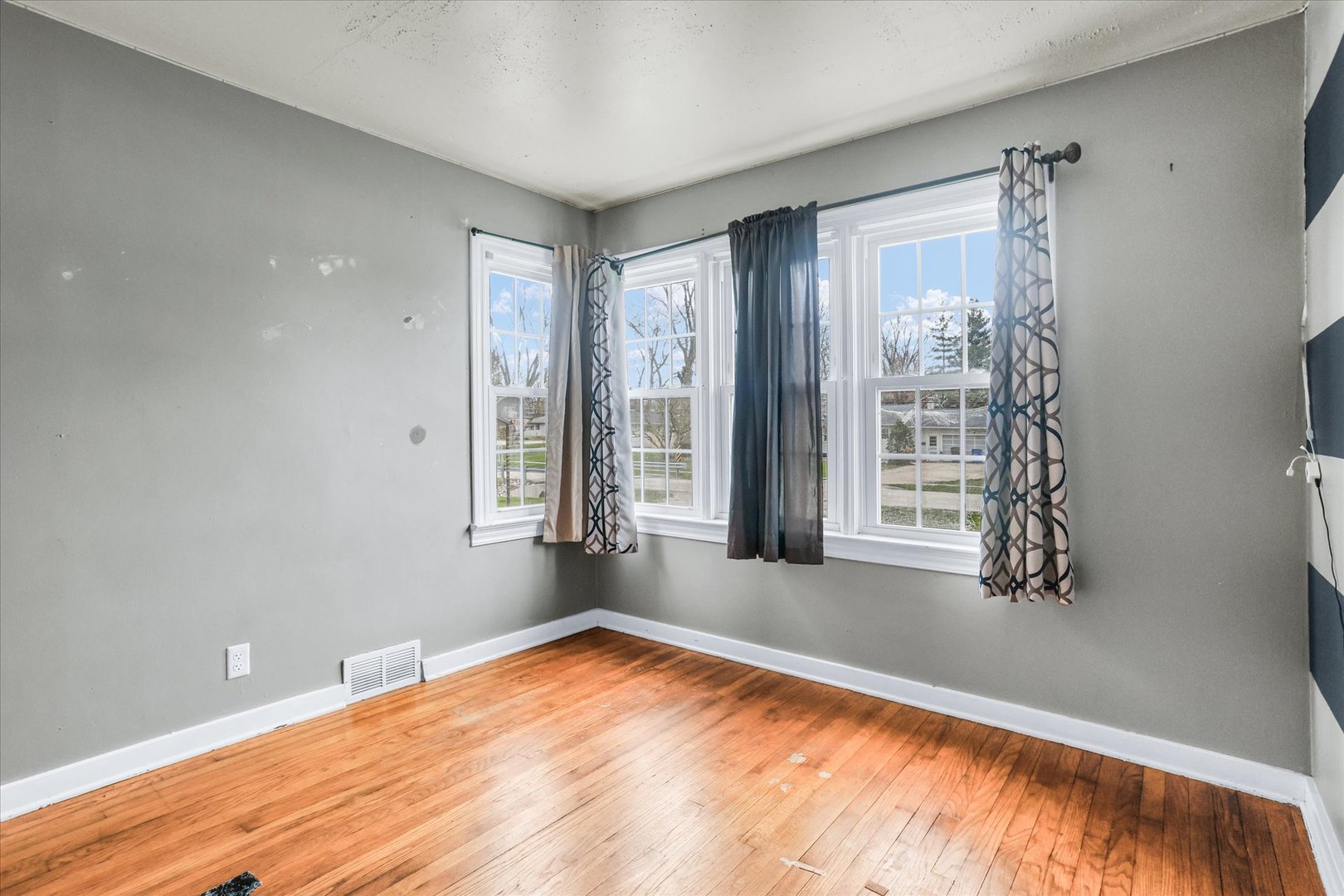 3234 East Fulton Avenue Decatur, IL 62521 - Photo 26 of 34 a view of an empty room with wooden floor and a window