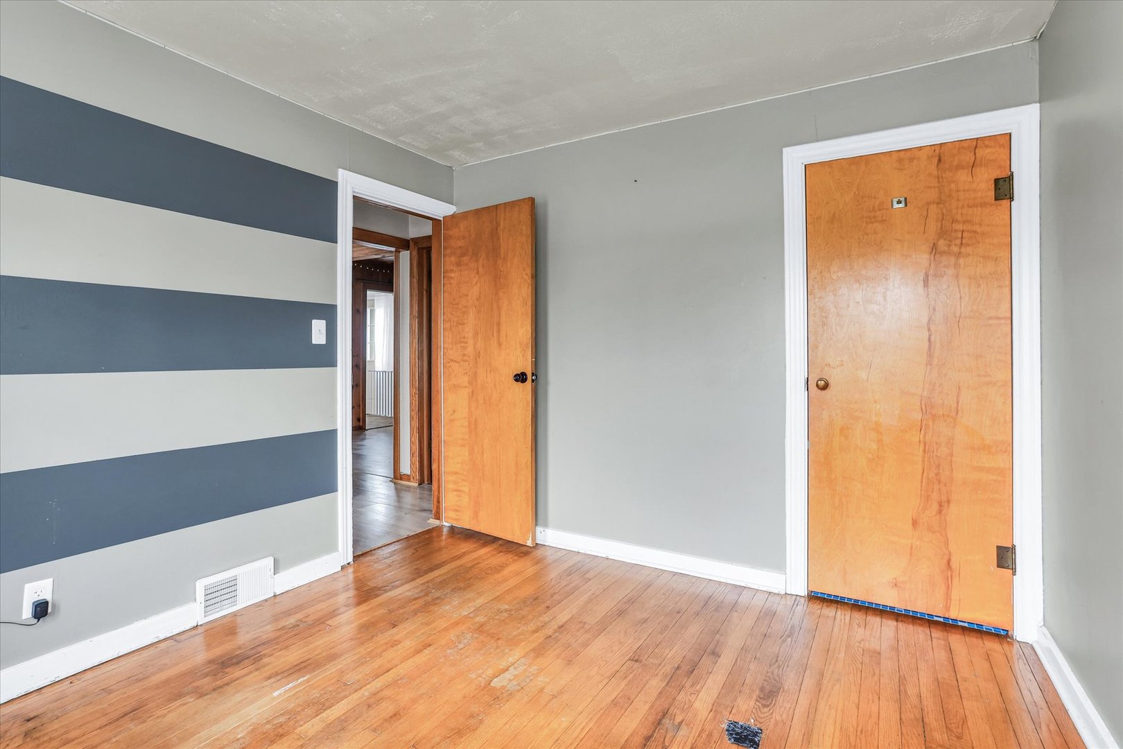3234 East Fulton Avenue Decatur, IL 62521 - Photo 27 of 34 a view of an empty room with wooden floor and a window
