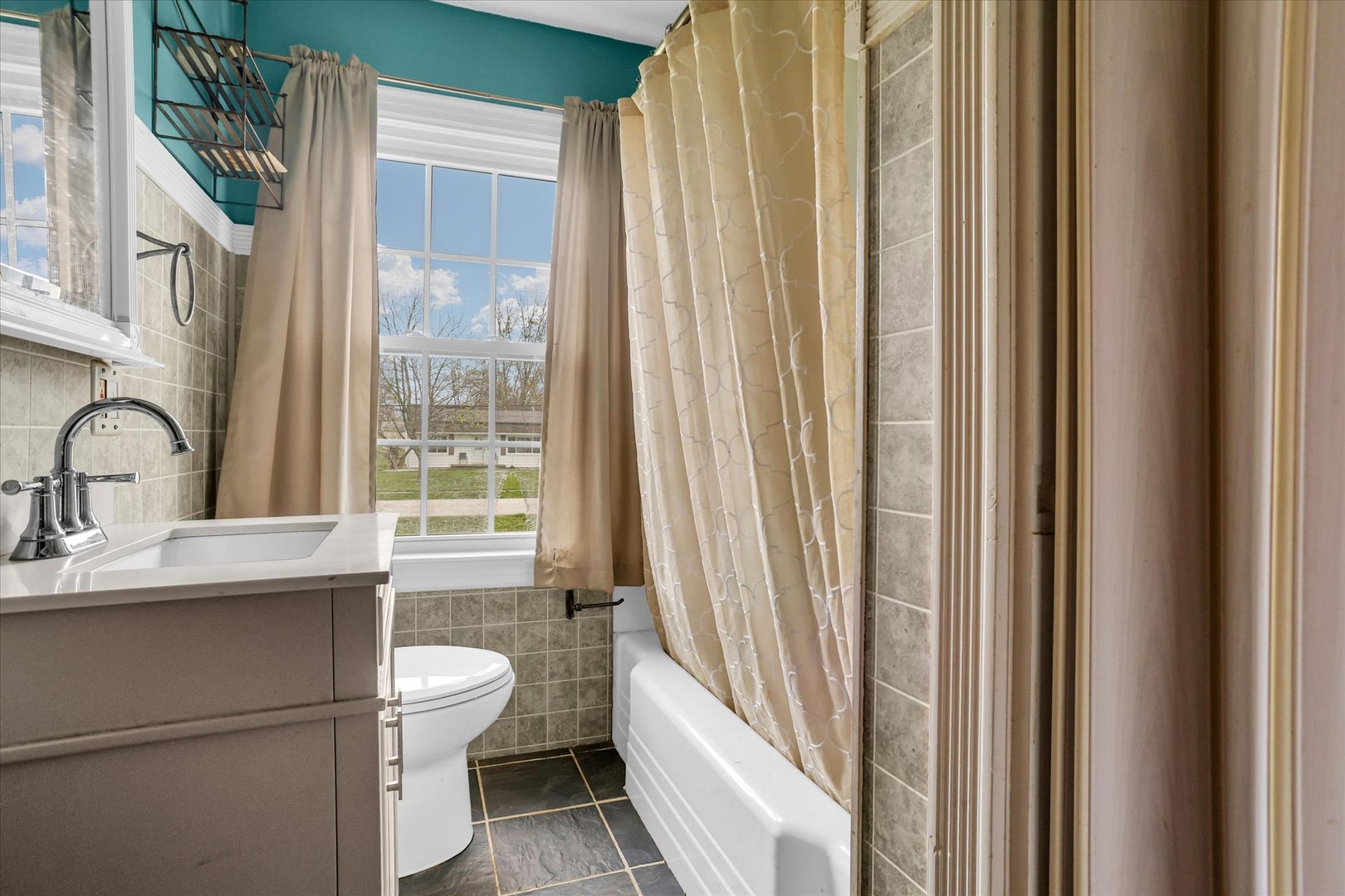 3234 East Fulton Avenue Decatur, IL 62521 - Photo 28 of 34 a bathroom with a sink a toilet and a mirror