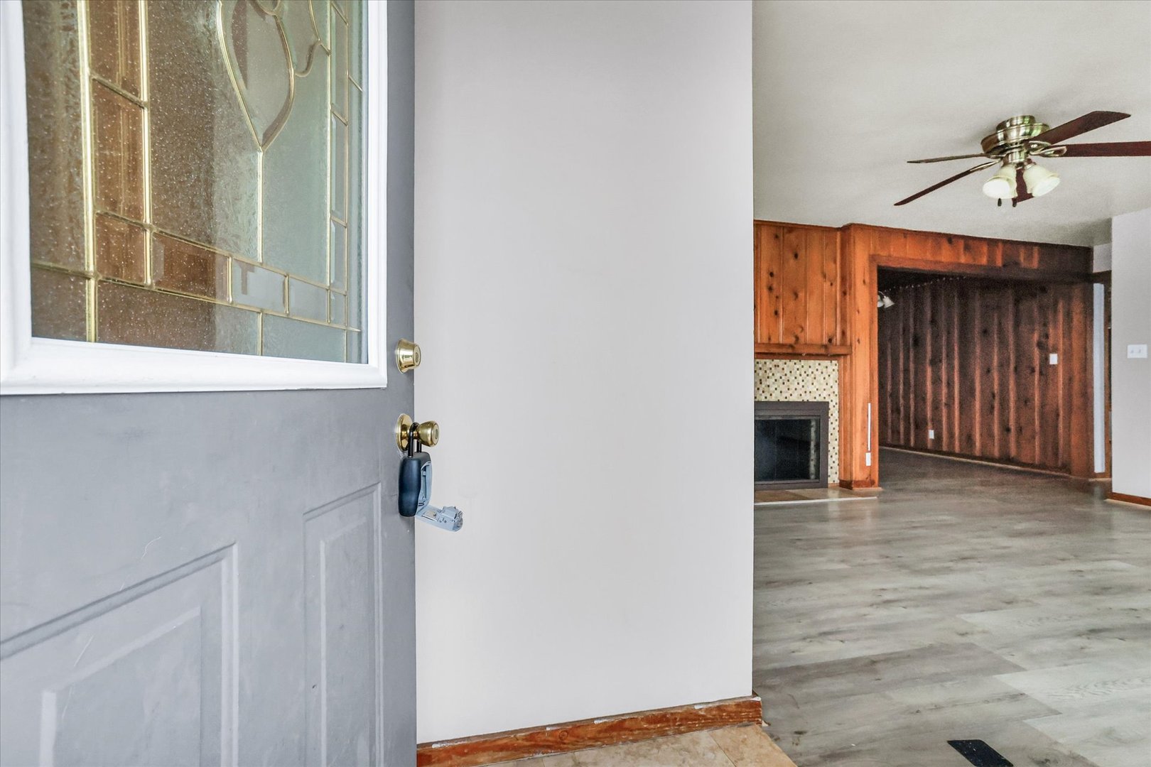 3234 East Fulton Avenue Decatur, IL 62521 - Photo 5 of 34 a view of a hallway with wooden floor and a fireplace