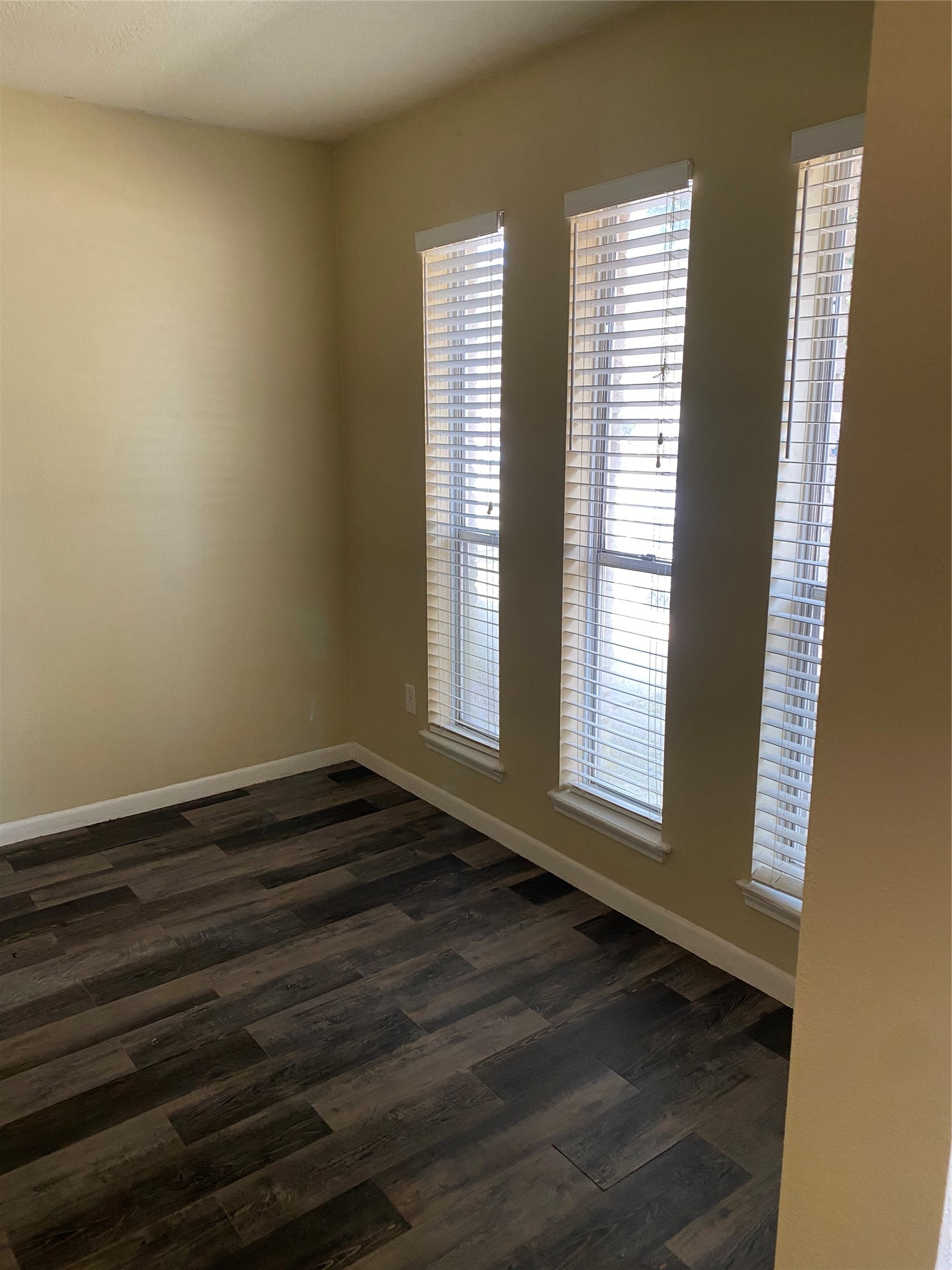 415 North Forest Boulevard Houston, TX 77090 - Photo 13 of 18 a view of an empty room with wooden floor and a window