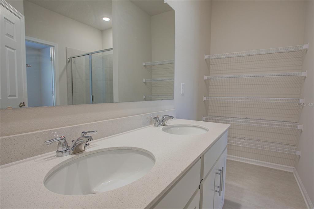 10 Freneau Lane Palm Coast, FL 32137 - Photo 16 of 29 a bathroom with a sink and a large mirror