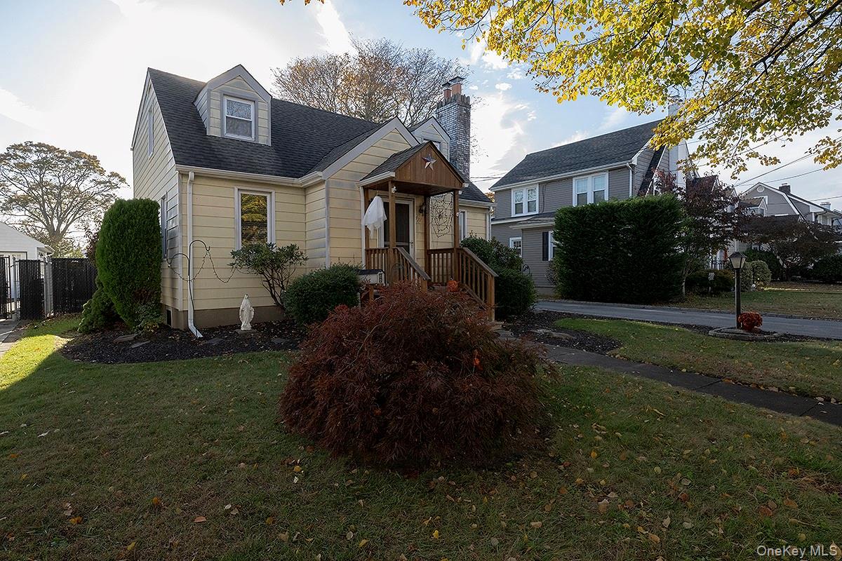 471 Windsor Place Oceanside, NY 11572 - Photo 1 of 1 a front view of house with yard and green space
