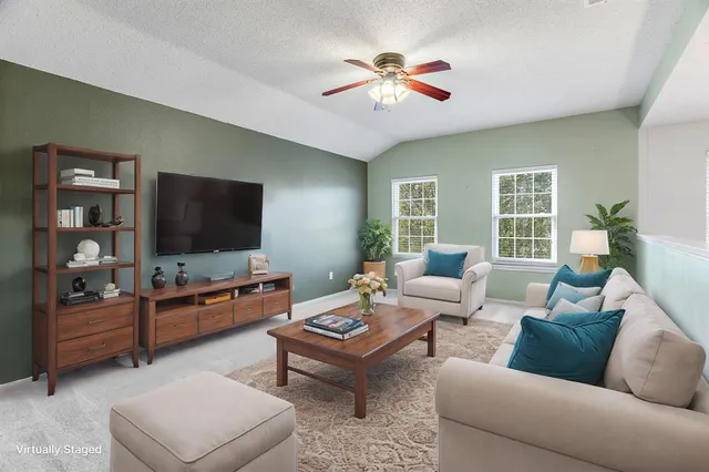a living room with furniture and a flat screen tv