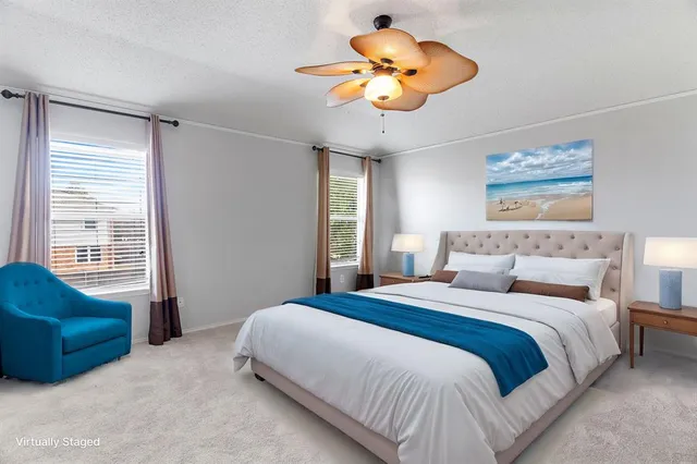 a bedroom with a bed couch and window