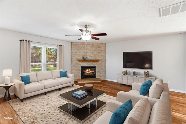 a living room with furniture a rug and a fireplace