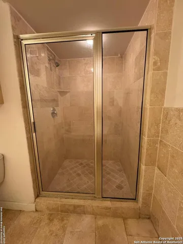 a bathroom with a glass door shower