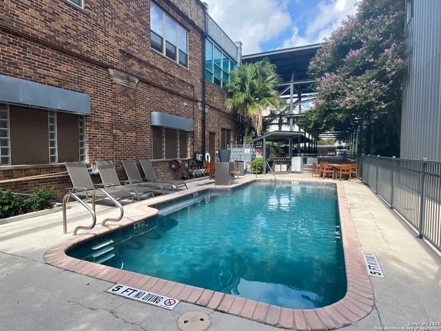 a view of a swimming pool with sitting area