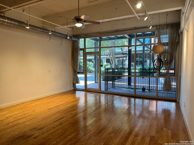 a view of a room with wooden floor